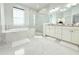 Bright bathroom with double vanity, shower, and modern finishes at 19730 Preservation Woods Dr, Lutz, FL 33558