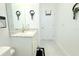 A clean bathroom features a vanity with marble countertop, matching black bathmat, and elegant decor at 19730 Preservation Woods Dr, Lutz, FL 33558