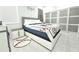 Modern bedroom features a baseball-themed decor, white tile flooring, and sliding closet doors for a sporty aesthetic at 19730 Preservation Woods Dr, Lutz, FL 33558