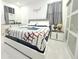 Modern bedroom features baseball-themed decor, white tile flooring, and a stylish gray and white color scheme at 19730 Preservation Woods Dr, Lutz, FL 33558