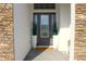 Inviting entryway featuring a decorative glass door, neutral finishes, and space for plants at 19730 Preservation Woods Dr, Lutz, FL 33558