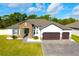 Beautiful single-story home with stone accents, a well-manicured lawn, and a paver driveway at 19730 Preservation Woods Dr, Lutz, FL 33558