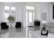 Bright foyer featuring two black swivel chairs and elegant entryway with glass paneled front door at 19730 Preservation Woods Dr, Lutz, FL 33558