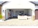 Open garage setup with a partial kitchen and seating, ideal for versatile usage and entertainment at 19730 Preservation Woods Dr, Lutz, FL 33558