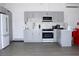 Well-lit kitchen with gray cabinets and stainless steel appliances at 19730 Preservation Woods Dr, Lutz, FL 33558