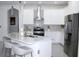 Well-equipped kitchen featuring stainless steel appliances, a kitchen island, and white cabinetry at 19730 Preservation Woods Dr, Lutz, FL 33558