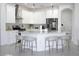 Modern kitchen with stainless steel appliances, white cabinets, and a stylish kitchen island at 19730 Preservation Woods Dr, Lutz, FL 33558