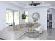 Living room featuring neutral decor, a cozy sectional sofa, and access to the outdoor patio at 19730 Preservation Woods Dr, Lutz, FL 33558