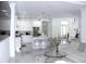Open-concept living space with a sleek, modern kitchen, stylish bar stools and view of the front entrance at 19730 Preservation Woods Dr, Lutz, FL 33558