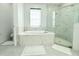 Elegant bathroom with tub, shower, and white marble tiling at 19730 Preservation Woods Dr, Lutz, FL 33558