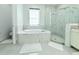 Elegant bathroom with tub, shower, and white marble tiling at 19730 Preservation Woods Dr, Lutz, FL 33558