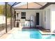 The outdoor kitchen is conveniently located near the pool, and is equipped with a grill and stainless refrigerator at 19730 Preservation Woods Dr, Lutz, FL 33558
