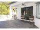 Cozy outdoor seating area on a covered patio, perfect for enjoying the view of the pool at 19730 Preservation Woods Dr, Lutz, FL 33558