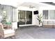 Relaxing covered patio with comfortable seating, ceiling fan, and view of the outdoor space at 19730 Preservation Woods Dr, Lutz, FL 33558