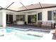 A screened-in pool with an integrated spa and outdoor seating provides an ideal entertaining space at 19730 Preservation Woods Dr, Lutz, FL 33558
