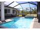A screened pool boasts crystal-clear water, an integrated spa, and a backdrop of lush greenery at 19730 Preservation Woods Dr, Lutz, FL 33558