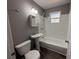 The bathroom has a white subway-tiled shower over tub, pedestal sink, and toilet at 203 D Street, Brooksville, FL 34601