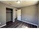 This bedroom features hardwood floors, neutral paint, and an open closet at 203 D Street, Brooksville, FL 34601