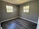 This bedroom features hardwood floors, neutral paint, and a double-hung window at 203 D Street, Brooksville, FL 34601