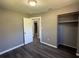 The neutral-painted bedroom showcases open closet and hardwood flooring at 203 D Street, Brooksville, FL 34601