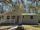 Well-maintained home featuring a cozy front porch and neat landscaping in a serene setting at 203 D Street, Brooksville, FL 34601