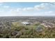An aerial view showcases multiple baseball fields in a park-like setting, surrounded by trees, and a small pond at 2213 Spanish Vistas Dr, Dunedin, FL 34698