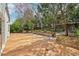 This backyard features tiered garden beds, mature trees, and a stained concrete patio at 2213 Spanish Vistas Dr, Dunedin, FL 34698