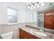 Well-lit bathroom features granite countertop, cherrywood cabinets and shower at 2213 Spanish Vistas Dr, Dunedin, FL 34698