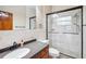 Well-lit bathroom with a glass shower, vanity sink and dark wood cabinets at 2213 Spanish Vistas Dr, Dunedin, FL 34698