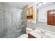 Well-lit bathroom features a glass enclosed shower with silver fixtures and a tiled sink at 2213 Spanish Vistas Dr, Dunedin, FL 34698
