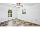 White bedroom with dual windows, tiled floor and neutral walls at 2213 Spanish Vistas Dr, Dunedin, FL 34698
