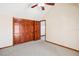 Bedroom with wood closet and light carpet, wood door, and baseboard at 2213 Spanish Vistas Dr, Dunedin, FL 34698