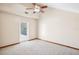 This bedroom features neutral walls, a patterned carpet, and a ceiling fan at 2213 Spanish Vistas Dr, Dunedin, FL 34698