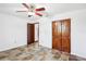 Bedroom with tiled floor, fan and closet doors at 2213 Spanish Vistas Dr, Dunedin, FL 34698