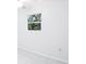 Bright bedroom features tile floors with a window view of lush, green plants at 2213 Spanish Vistas Dr, Dunedin, FL 34698