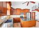 Kitchen with stainless appliances, wood cabinets, and tile backsplash at 2213 Spanish Vistas Dr, Dunedin, FL 34698