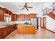 Kitchen with stainless appliances, an island, and wood cabinets at 2213 Spanish Vistas Dr, Dunedin, FL 34698