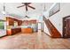 Open floor plan kitchen with wooden cabinetry, island and view of staircase at 2213 Spanish Vistas Dr, Dunedin, FL 34698