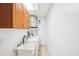 Efficient laundry room with tile floor, cabinetry, utility sink, washer and dryer at 2213 Spanish Vistas Dr, Dunedin, FL 34698