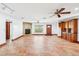 Bright living space features a stone fireplace, a large window, and cabinetry with sink at 2213 Spanish Vistas Dr, Dunedin, FL 34698