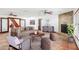 Staged living room with a stone fireplace, neutral sofa, and tile flooring at 2213 Spanish Vistas Dr, Dunedin, FL 34698