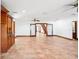 Large living space with tile floors, wooden cabinetry, and open access to stairway at 2213 Spanish Vistas Dr, Dunedin, FL 34698