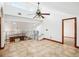 Sun-lit living room features vaulted ceilings, a ceiling fan, tile flooring and a staircase at 2213 Spanish Vistas Dr, Dunedin, FL 34698