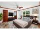 Staged main bedroom suite boasts a TV and ensuite bath, and exterior views at 2213 Spanish Vistas Dr, Dunedin, FL 34698