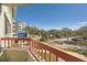 Balcony with a red railing and a view of the parking lot and surrounding buildings at 2333 Feather Sound Dr # A204, Clearwater, FL 33762