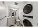 Bathroom with sink, commode, and a stacked washer and dryer at 2333 Feather Sound Dr # A204, Clearwater, FL 33762
