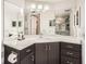 Modern bathroom with a corner vanity, dark cabinetry, and a large mirror at 2333 Feather Sound Dr # A204, Clearwater, FL 33762