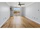 This bedroom offers hardwood floors, ceiling fan, and a private balcony at 2333 Feather Sound Dr # A204, Clearwater, FL 33762