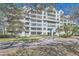 Stunning multi-story condominium with lush landscaping, driveway, and well-maintained facade surrounded by mature trees at 2333 Feather Sound Dr # A204, Clearwater, FL 33762