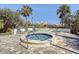 Outdoor community hot tub with lush landscaping and chairs at 2333 Feather Sound Dr # A204, Clearwater, FL 33762